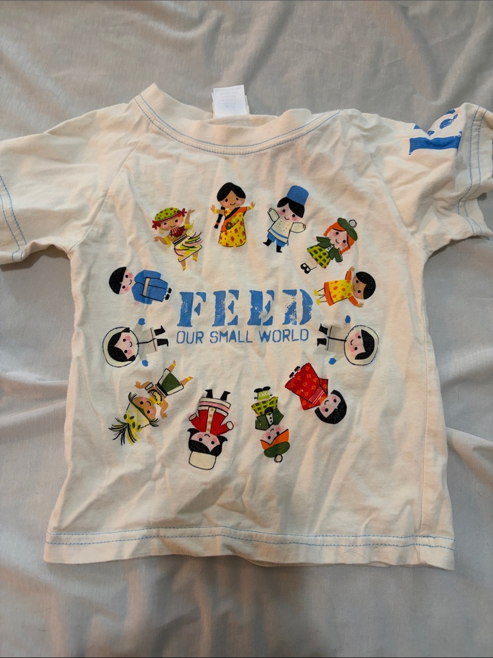 Disney Cream Tee with Blue FEED Text and Multicultural Characters